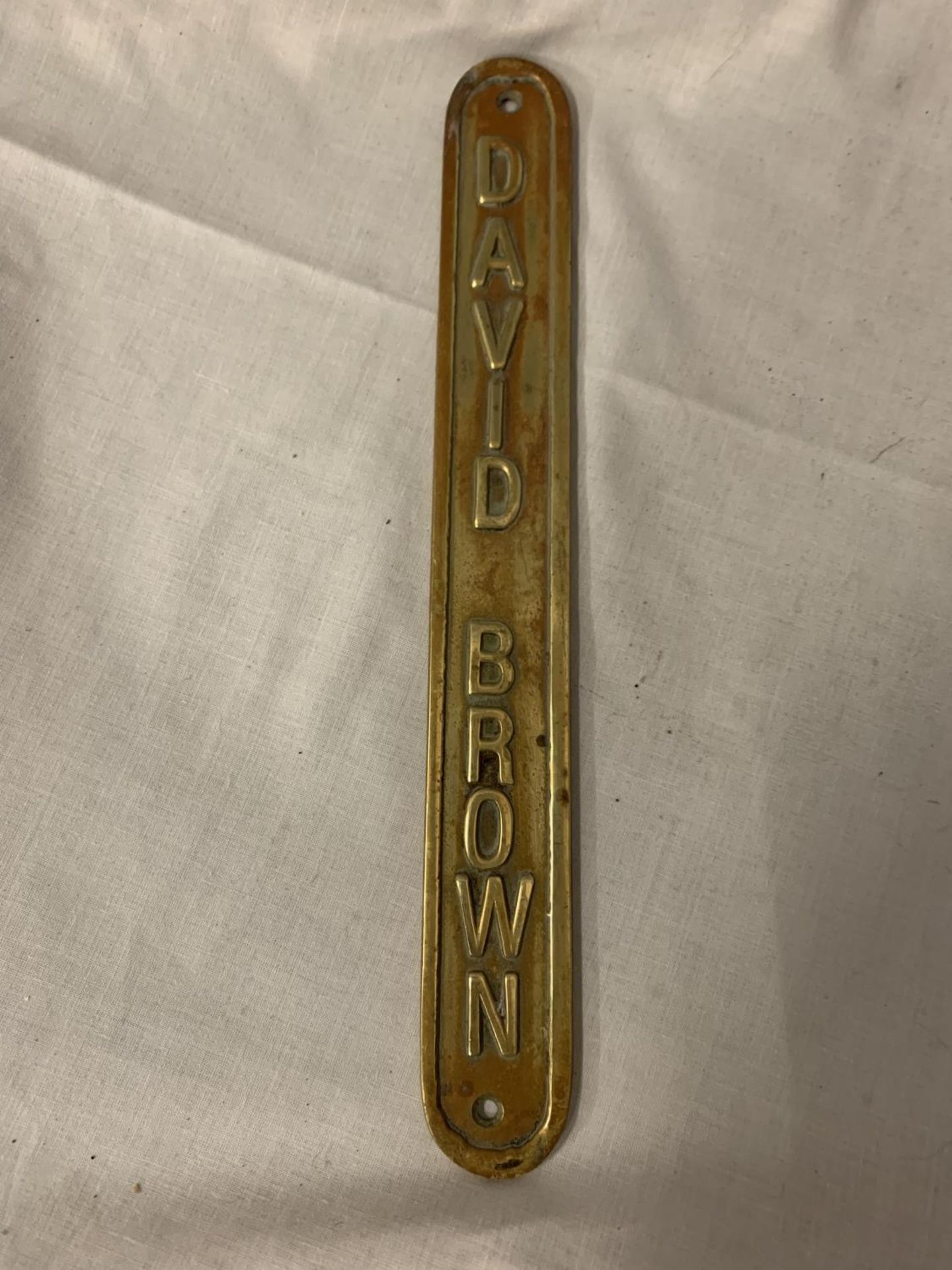 A BRASS 'DAVID BROWN' DOOR PLATE, 31.5CM LENGTH