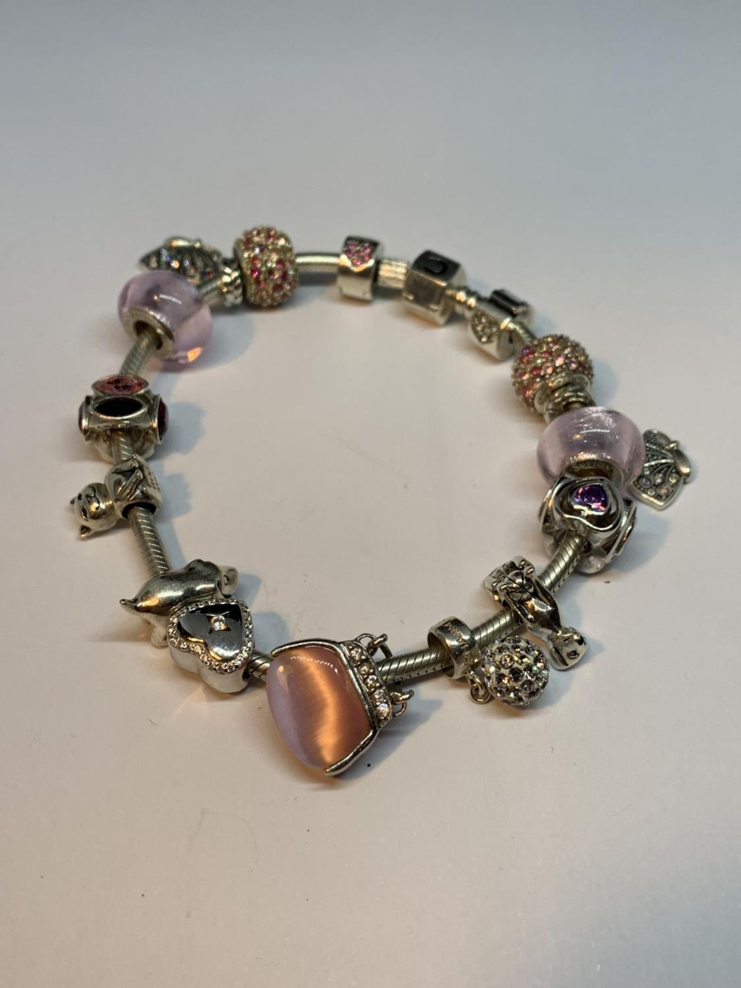 A CHAMILIA SILVER BRACELET WITH FOURTEEN CHARMS
