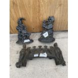 A PAIR OF CAST IRON PUNCH AND JUDY DOORSTOPS AND A DECORATIVE FIRE FRONT