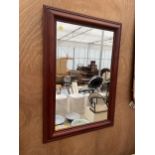 A LARGE WOODEN FRAMED MIRROR (74CM X 103CM)