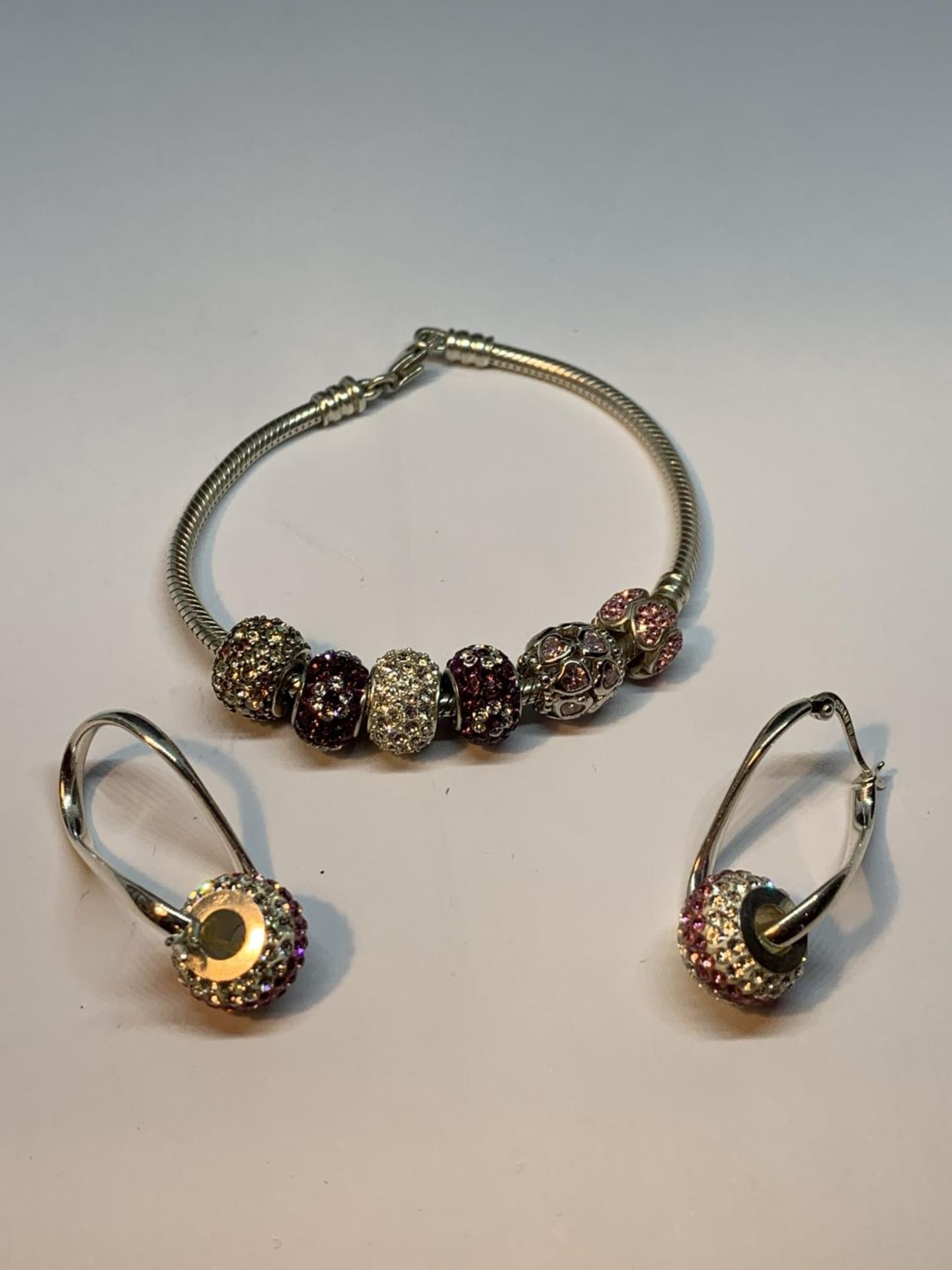 A SILVER PANDORA STYLE BRACELET WITH SIX CHARMS AND A PAIR OF CHARM EARRINGS