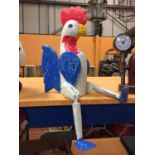 A WOODEN ROOSTER SHELF PUPPET