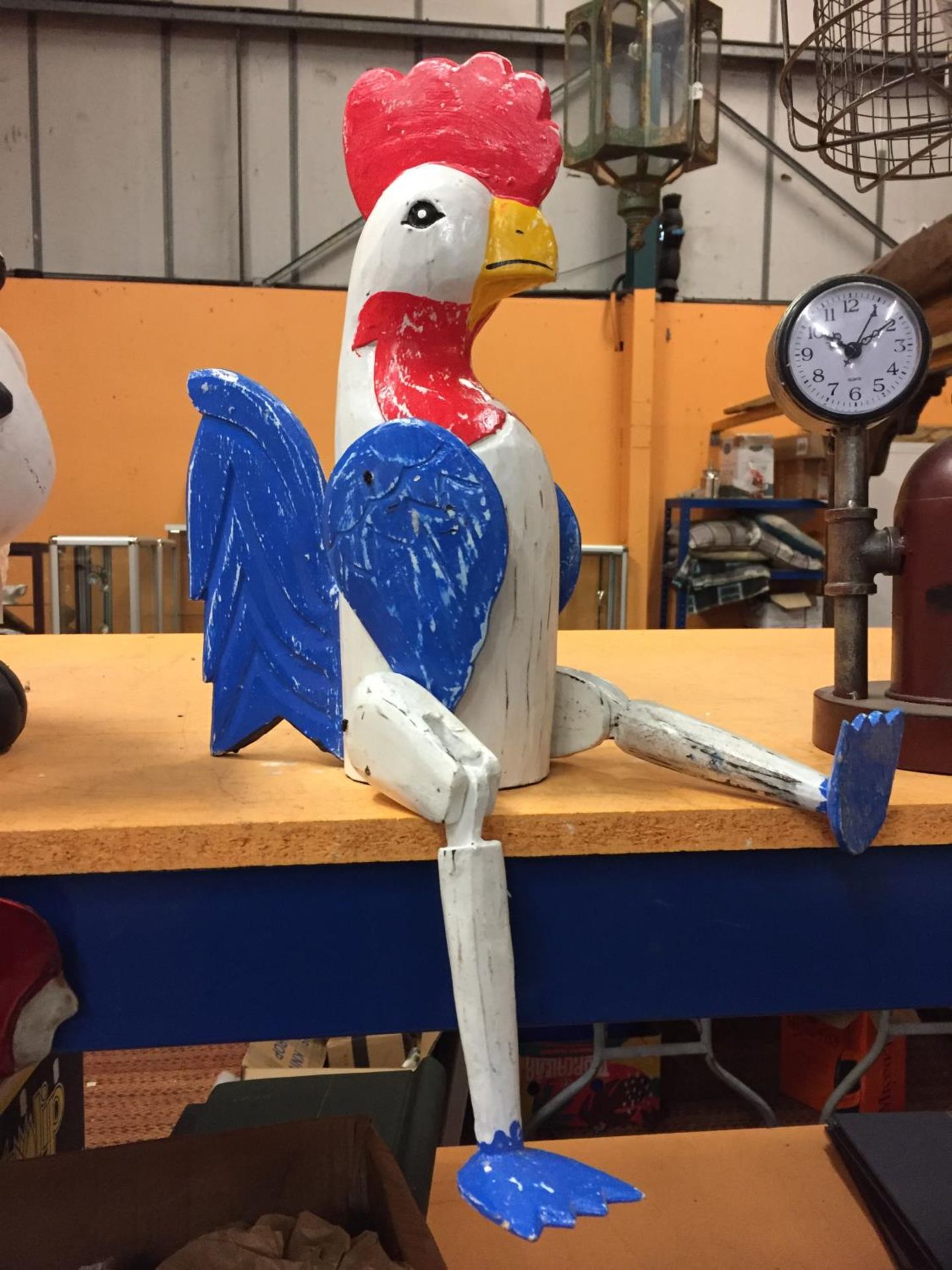 A WOODEN ROOSTER SHELF PUPPET