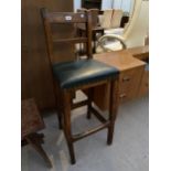 A TALL VICTORIAN STOOL WITH BAR BACK