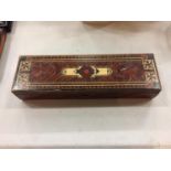 AN INLAID MARQUETRY BOX CONTAINING WRITING IMPLEMENTS AND AN INKWELL