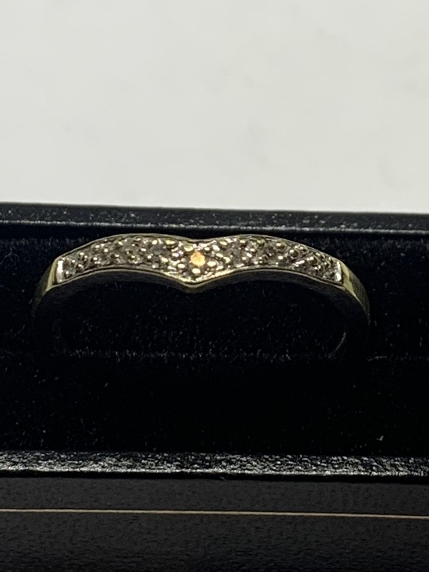 A 9 CARAT GOLD RING WITH DIAMONDS IN A WISHBONE DESIGN SIZE O WITH A PRESENTATION BOX