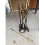 A BRASS FIRESIDE COMPANION SET AND A BRASS TOASTING FORK