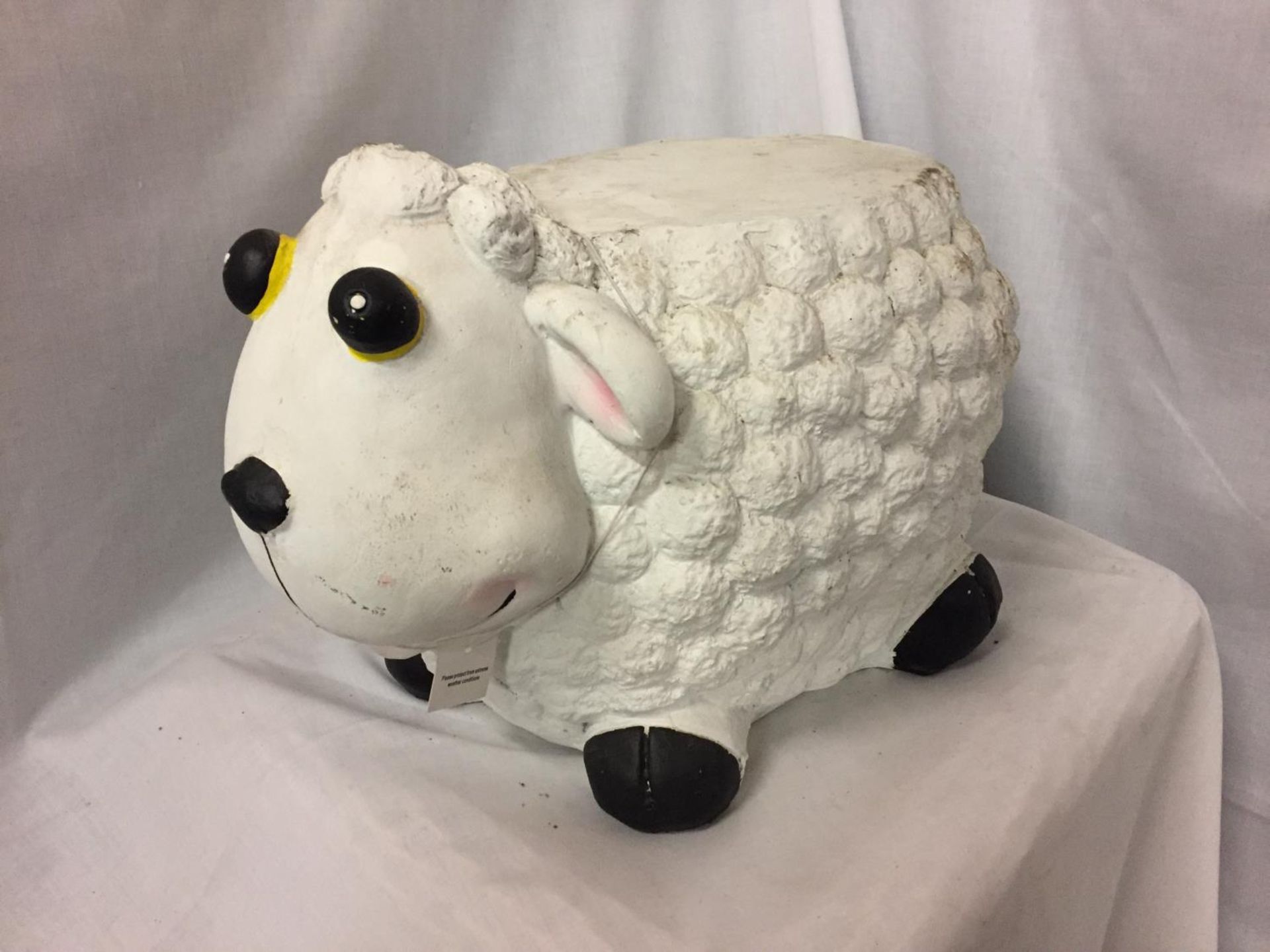 A WHITE AND DECORATIVE CERAMIC SHEEP STOOL