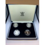 A BOX OF FOUR SILVER PROOF ONE POUND COINS 1985,1986, 1995 AND 1998