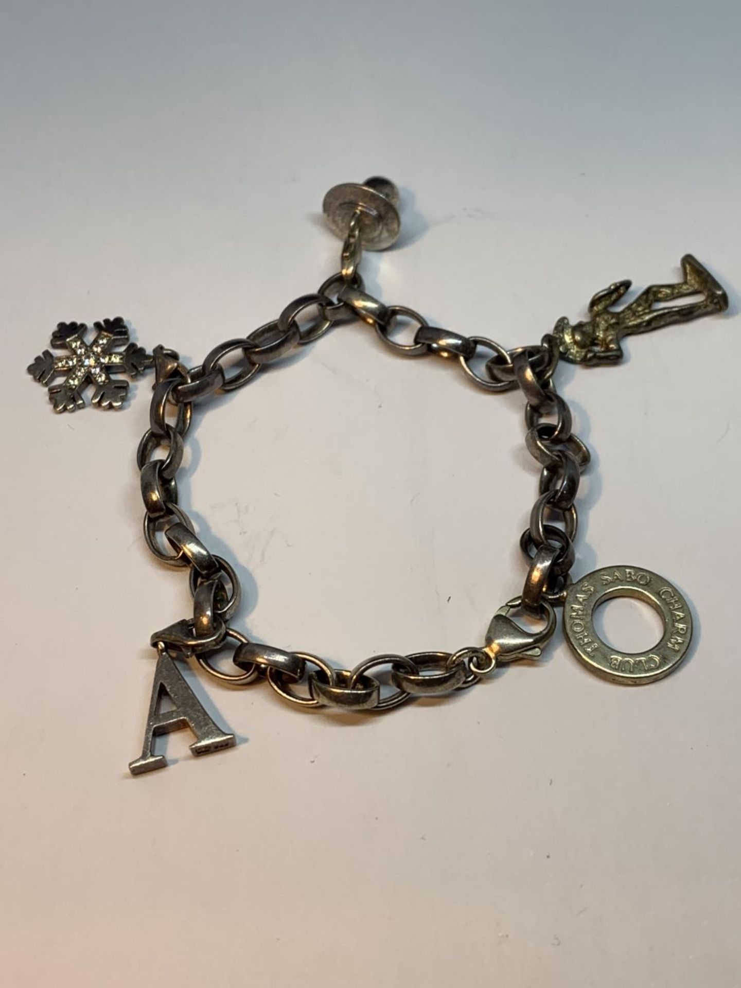 A THOMAS SABO CHARM BRACELET WITH FOUR CHARMS