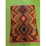 A 100% HAND KNOTTED BALUCHI WOOLLEN RUG IN BROWNS, RED, AND GREENS. SIZE 118CM X 80CM