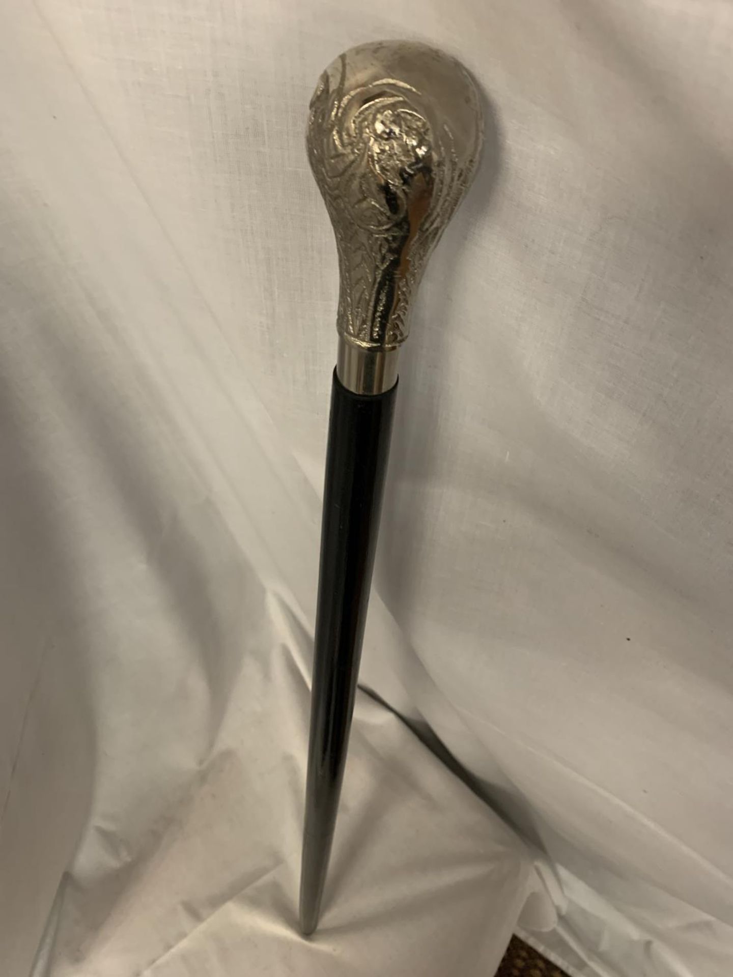 A BLACK WALKING CANE WITH WHITE METAL HANDLE - Image 3 of 3