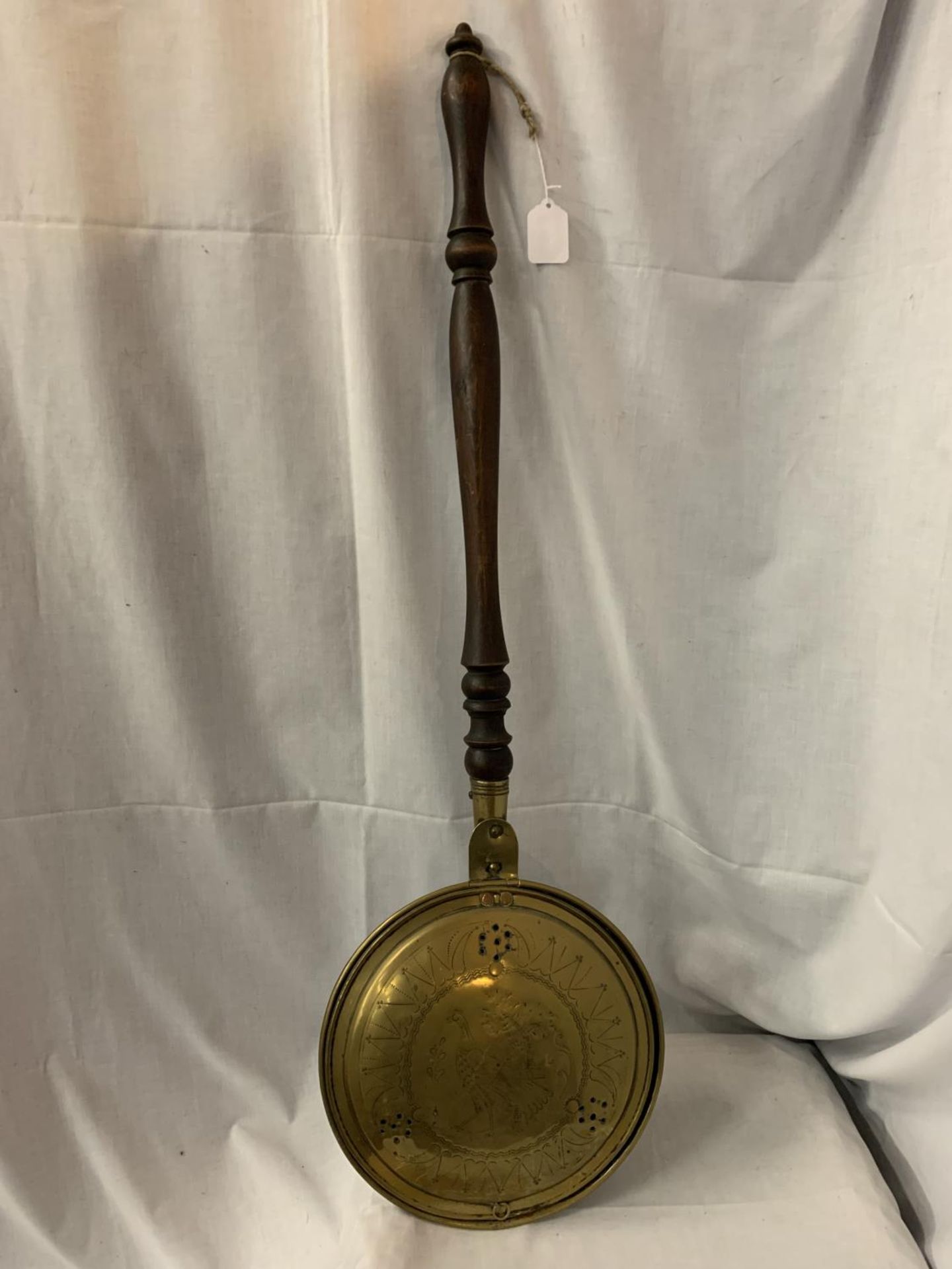 A BRASS BED WARMING PAN