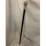 A BLACK WALKING CANE WITH WHITE METAL HANDLE