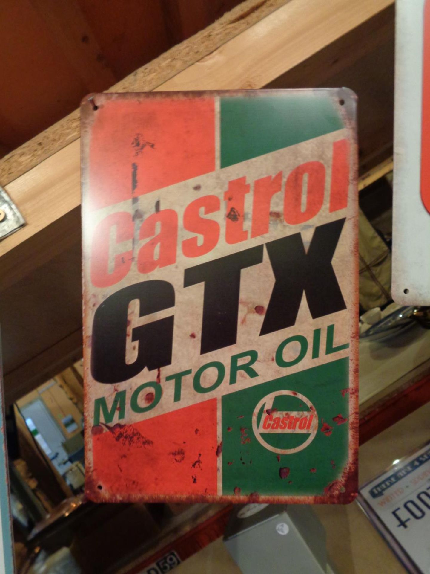A TIN 'CASTROL GTX MOTOR OIL' SIGN
