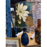 A CERAMIC BASED FLORAL SHADED LAMP