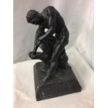 A HARD RESIN SCULPTURE OF A STRONG MAN BREAKING A STONE WITH THE WORDS ' PHOSPHERINE THE GREATEST OF