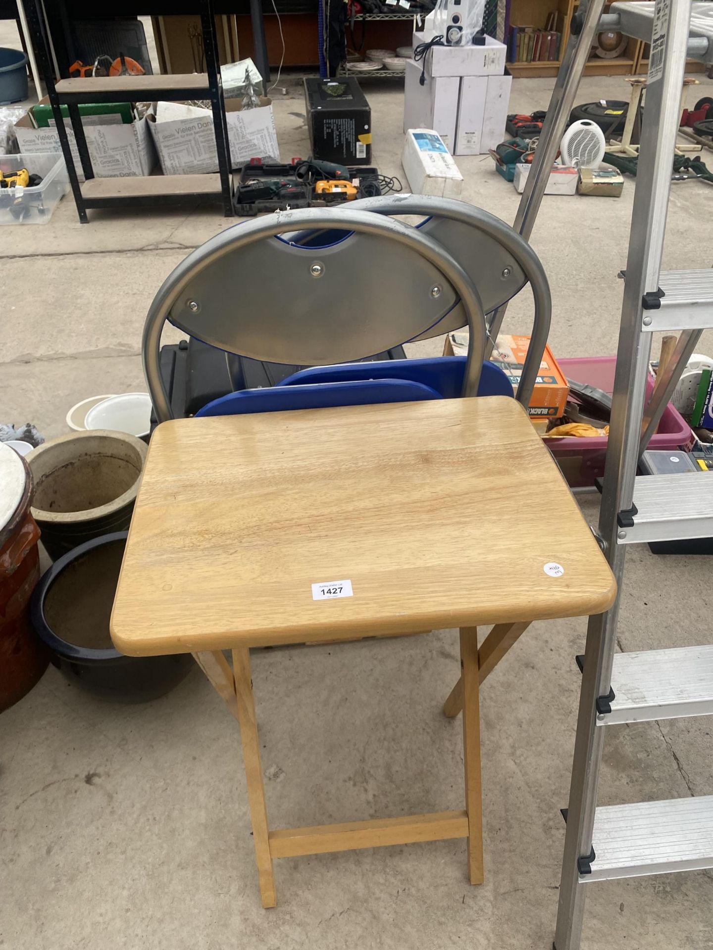 A WOODEN FOLDING TABLE AND TWO METAL FRAMED FOLDING CHAIRS