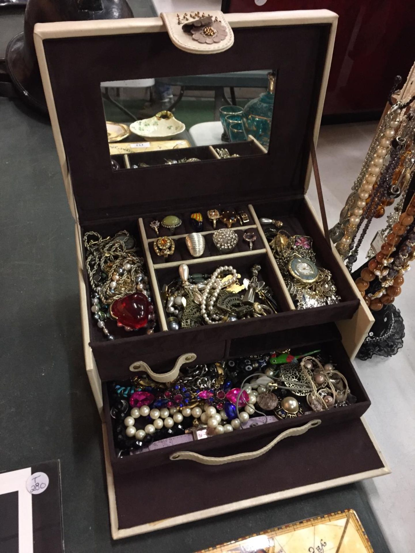 A LEATHER JEWELLERY BOX AND A MANNEQUIN CONTAINING A LARGE AMOUNT OF COSTUME JEWELLERY TO INCLUDE