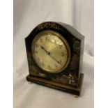 AN EBONISED MANTLE CLOCK WITH ORIENTAL DESIGN