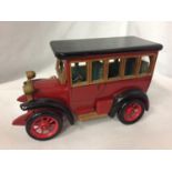 A WOODEN MODEL OF A VINTAGE MOTOR CAR