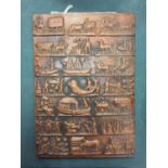 A TERRACOTTA WALL PLAQUE DEPICTING AFRICAN SCENES