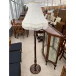 AN EARLY 20TH CENTURY OAK STANDARD LAMP WITH SHADE