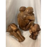 A SET OF THREE CARVED WOODEN FIGURES, ONE OF AN EMBRACING COUPLE, TWO INDIVIDUAL FIGURES