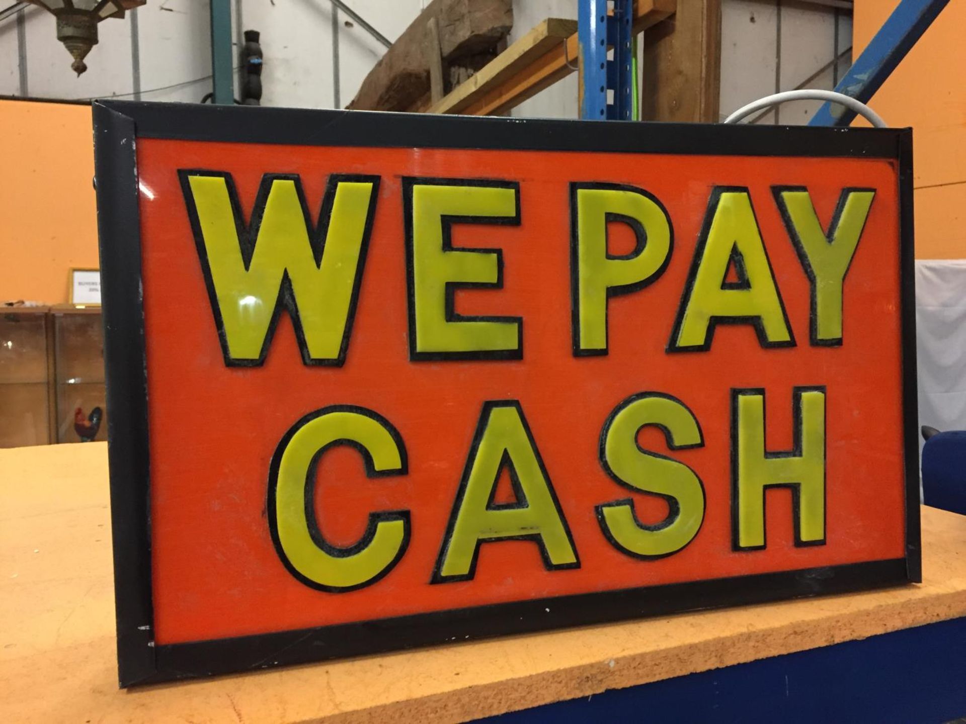 A WE PAY CASH ILLUMINATED LIGHT BOX SIGN