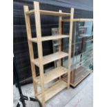 A WOODEN SHELVING UNIT