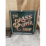 A VINTAGE WOODEN 'THE BRASS AND COPPER SHOP' SIGN