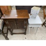 AN OAK JACOBEAN STYLE TWO DOOR CUPBOARD ON OPEN BASE, 20" WIDE, BEDSIDE TABLE AND LAMP