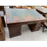 AN EDWARDIAN MAHOGANY PARTNERS DESK ENCLOSING TWELVE DRAWERS AND TWO CUPBOARDS WITH INSET LEATHER