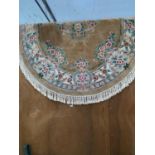 AN OVAL CREAM AND FLORAL PATTERNED FRINGE RUG