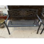 A METAL SLATTED GARDEN BENCH WITH FLORAL BACK