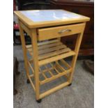 A TILED TOP KITCHEN TROLLEY TABLE