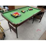 AN OMEGA POOL/SNOOKER TABLE, 55 X 29" AND A QUANTITY OF BALLS