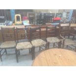 FIVE ELM AND BEECH COUNTRY CHAIRS WITH RUSH SEATS, ONE BEING A CARVER