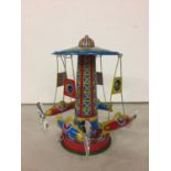 A TIN PLATE MERRY-GO-ROUND TOY