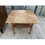 A TEAK COFFEE TABLE WITH LOWER SHELF