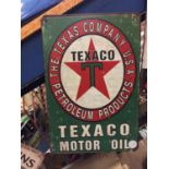 A GREEN TEXACO MOTOR OIL SIGN