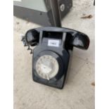 A RETRO BLACK ROTARY DIAL WALL MOUNTED TELEPHONE