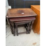 A NEST OF THREE OAK TABLES