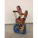 A TIN PLATE TOY WITH MONKEYS AT A CIRCUS