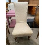 A VICTORIAN PRAYER CHAIR ON TURNED FRONT LEGS WITH WHITE PORCELAIN CASTERS