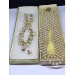 TWO BOXED NECKLACES ONE BEING A FIVE STRAND PEARL STYLE CHOKER AND THE OTHER A DECORATIVE PINK AND