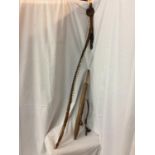 AN AFRICAN STYLE LEATHER AND FUR COVERED BOW AND A LEATHER QUIVER CONTAINING ARROWS