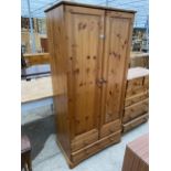 A MODERN PINE TWO DOOR WARDROE WITH TWO SHORT AND ONE LONG DRAWER TO THE BASE, 34" WIDE