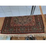 A RED PATTERNED FRINGE KANDAHAR RUG