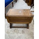 AN OAK MINIATURE SWIVEL TOP DROP-LEAF TABLE